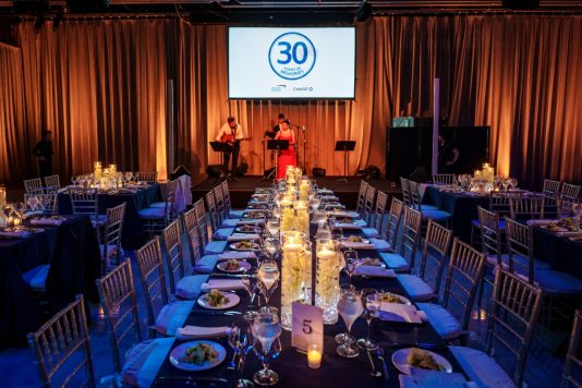 Candlelit banquet tables and stage