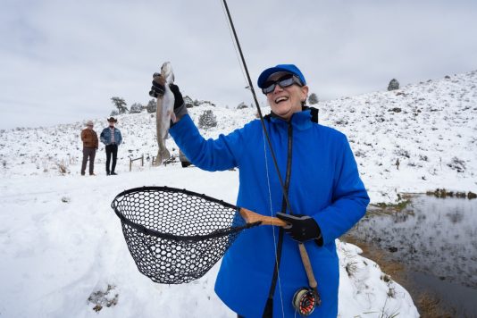 Guest displaying freshly caught trout