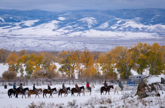 Horseback ride through snowy valley