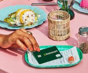 Woman paying for meal with Instacart credit card
