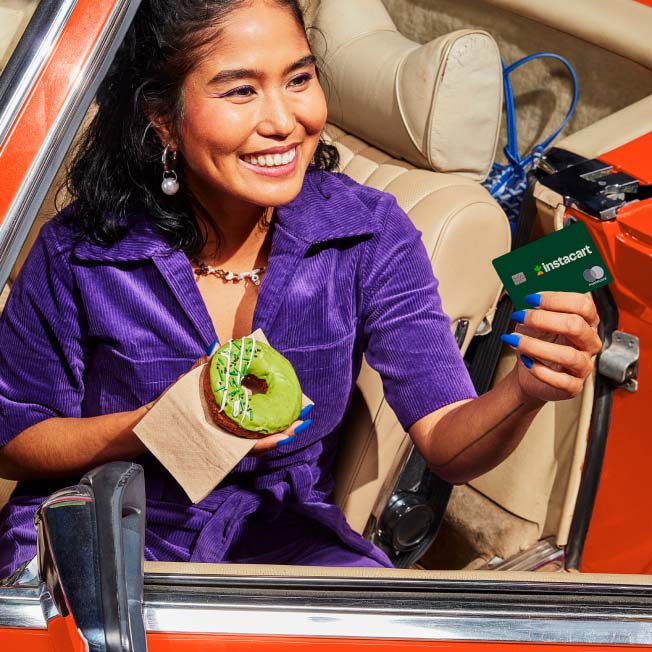 Woman in car using her Instacart credit card