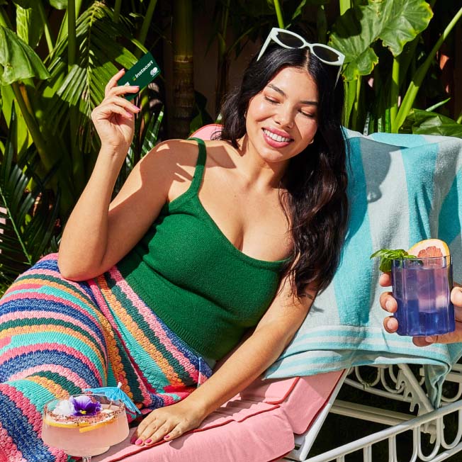 Woman sitting in lounge chair using her Instacart credit card