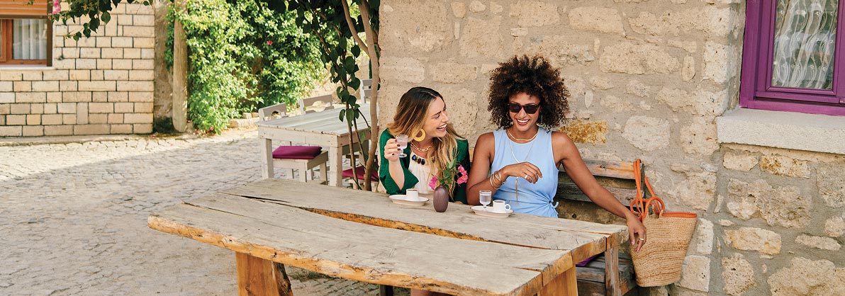 image of two women having a drink, laughing